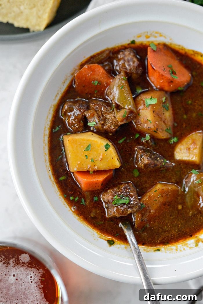 Guinness-Infused Irish Beef Stew 31 Irish Stout Beef Stew in a serving bowl, perfectly garnished