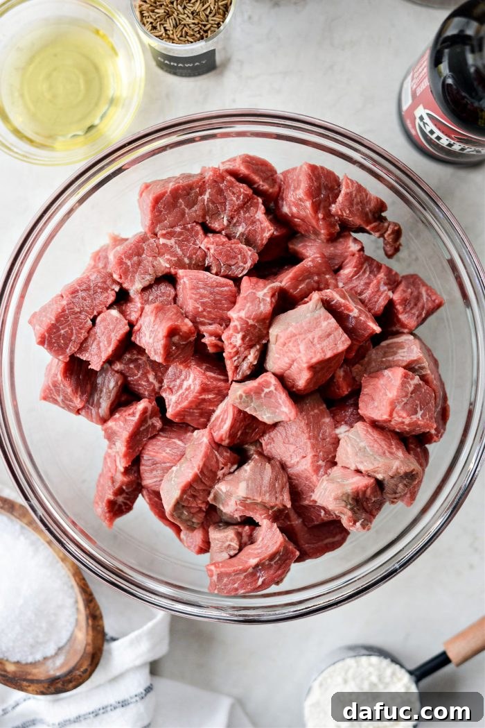 Guinness-Infused Irish Beef Stew 6 Cubed beef seasoned in a mixing bowl