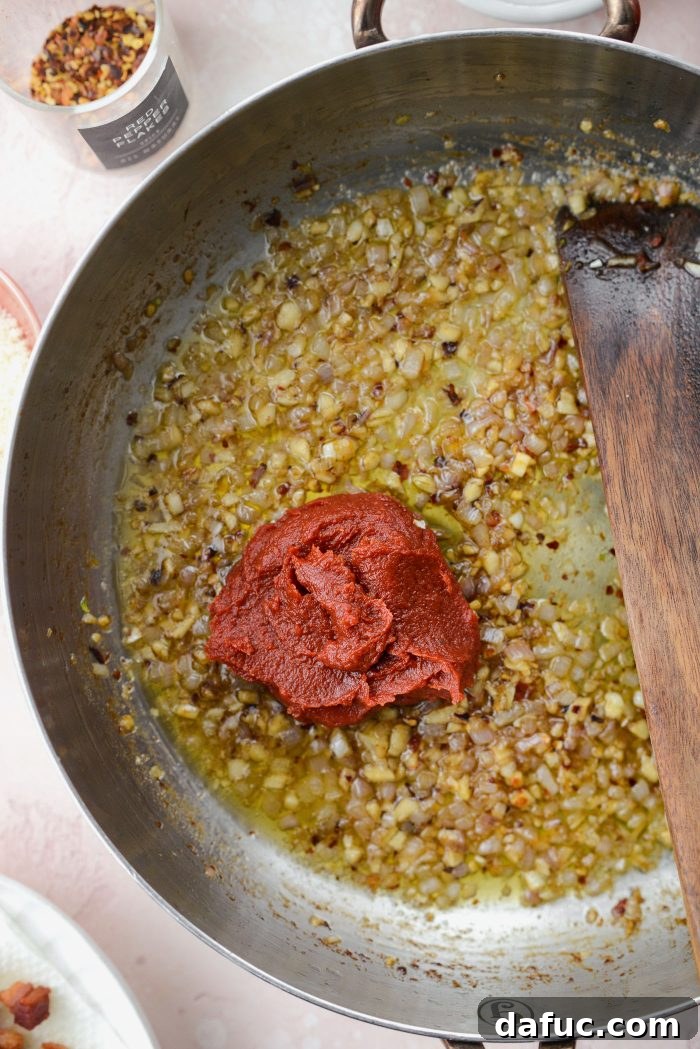 Creamy Blush Pasta 11 Adding tomato paste to the skillet