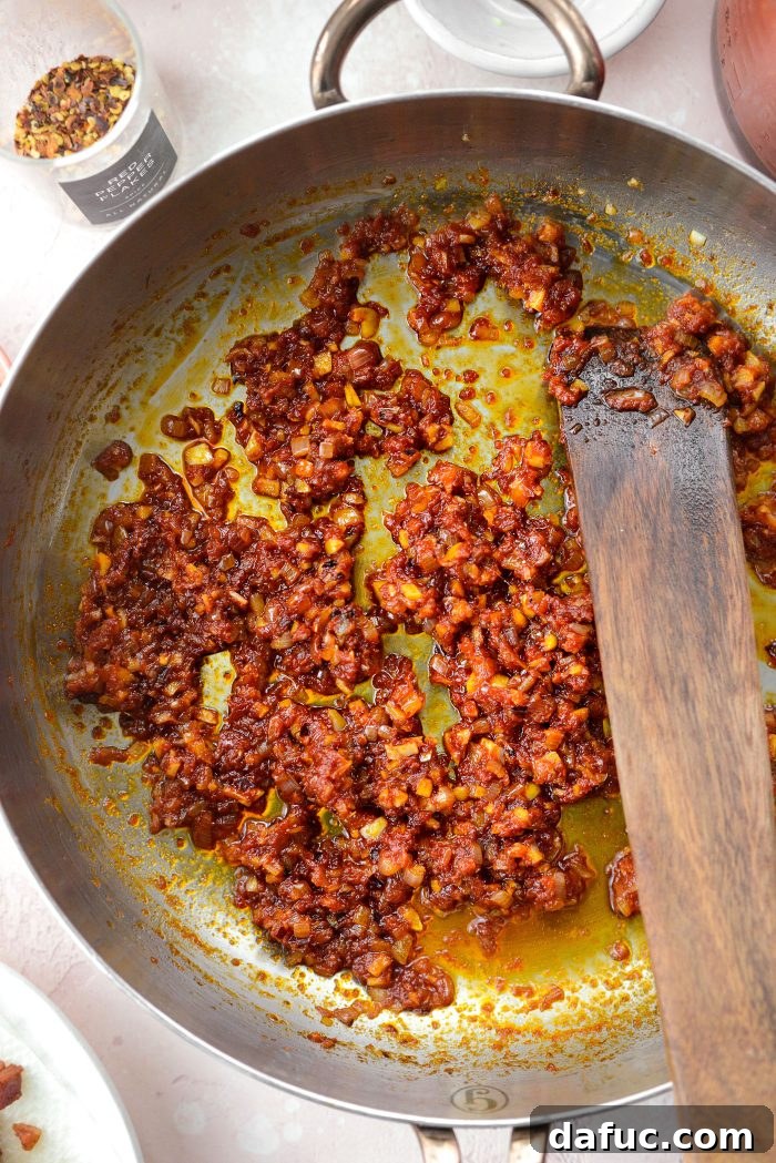 Creamy Blush Pasta 12 Stirring and cooking tomato paste until it deepens in color