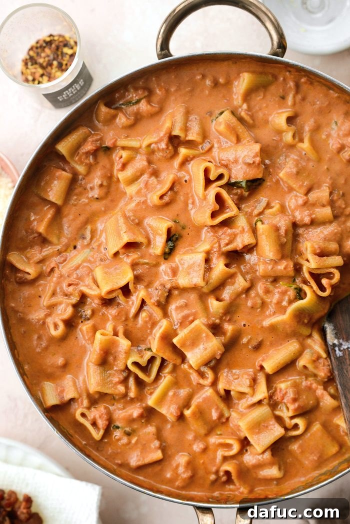 Creamy Blush Pasta 22 Tossing pasta with pink sauce to combine