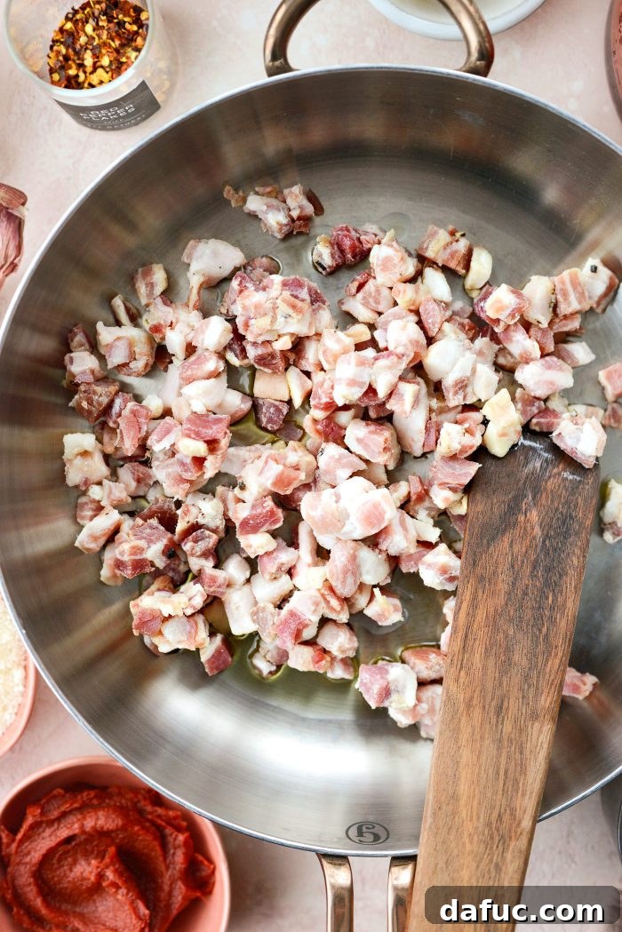 Creamy Blush Pasta 6 Adding olive oil and diced pancetta to a hot skillet