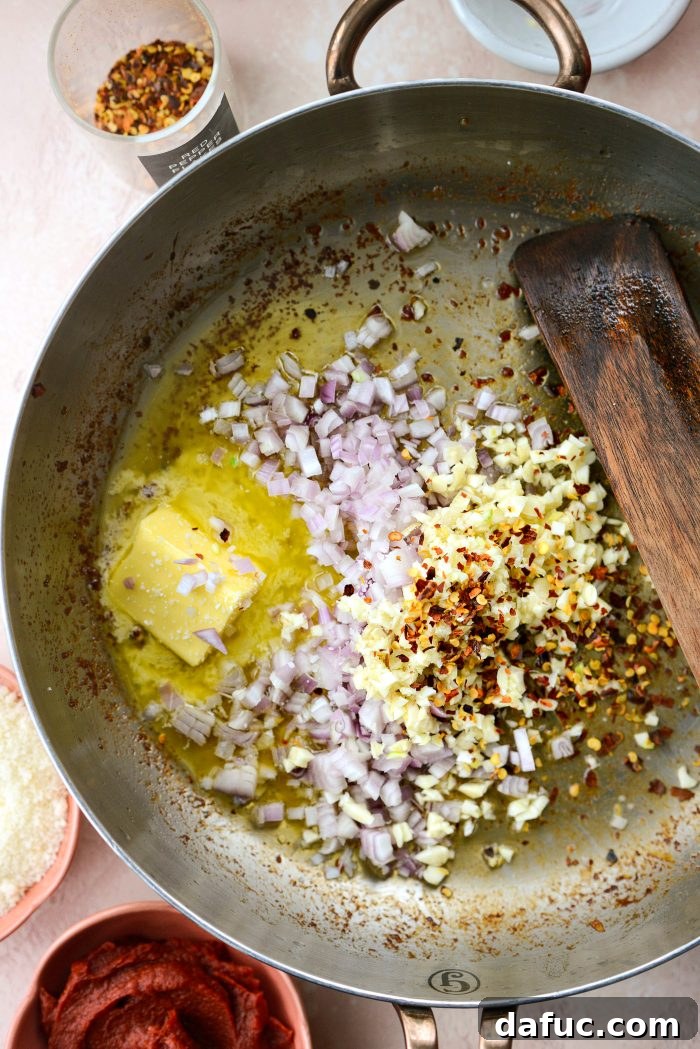 Creamy Blush Pasta 9 Adding butter, shallot, garlic, red pepper flakes, and salt to the skillet