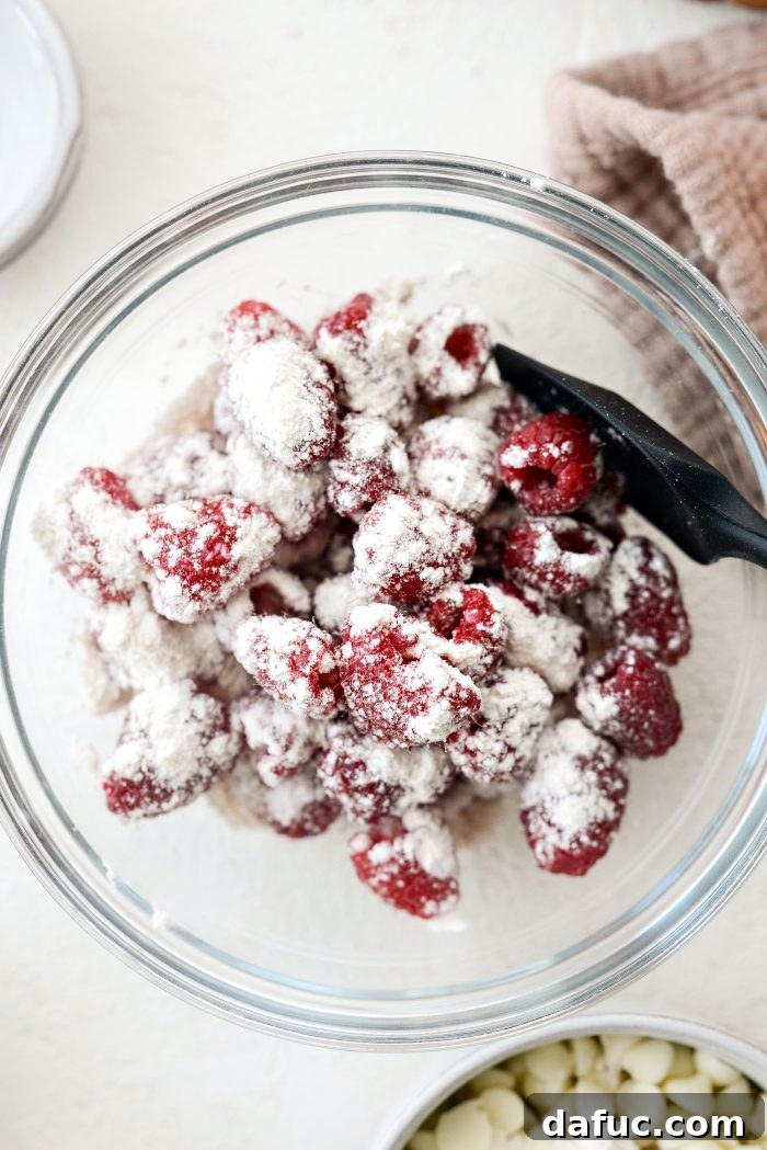 Tossing fresh raspberries in a small amount of flour