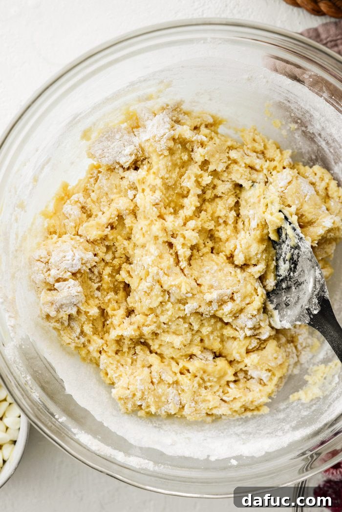 Stirring muffin batter until just combined, avoiding overmixing