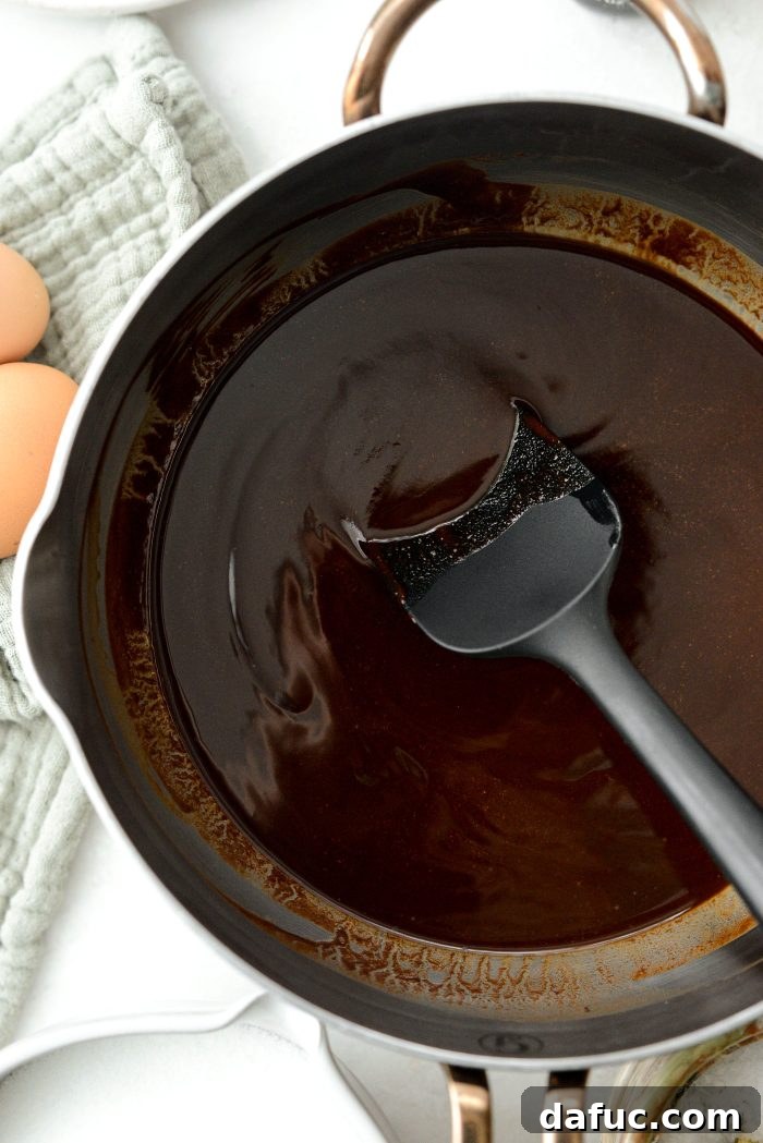 The smoothly melted butter and chocolate mixture in the saucepan, removed from heat