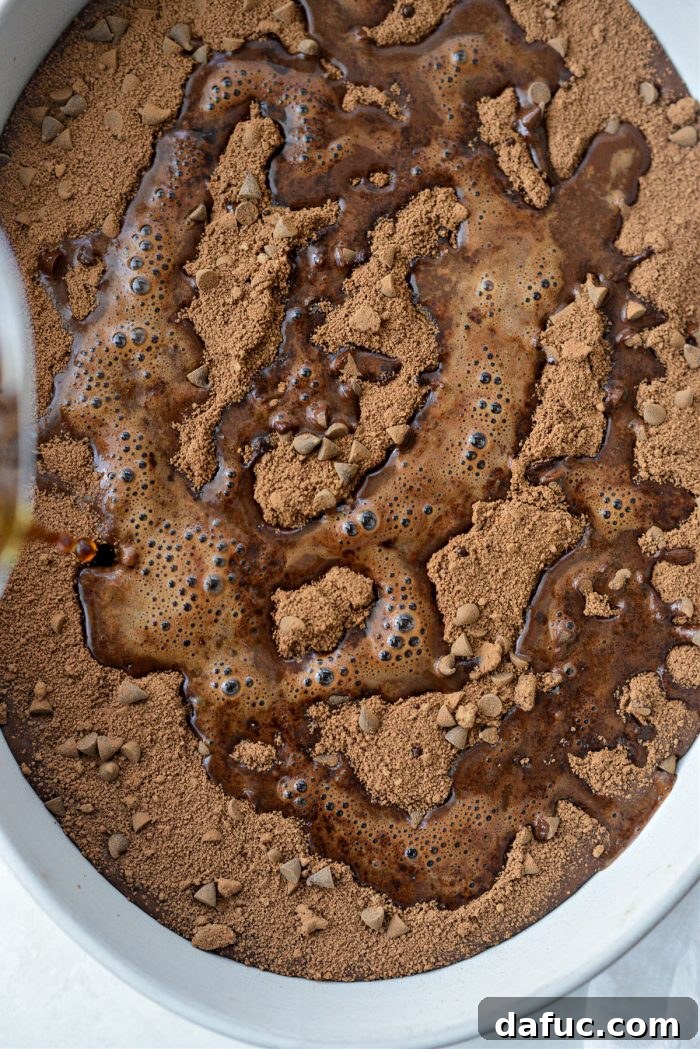 Pouring hot coffee directly over the brown sugar mixture on top of the cake batter
