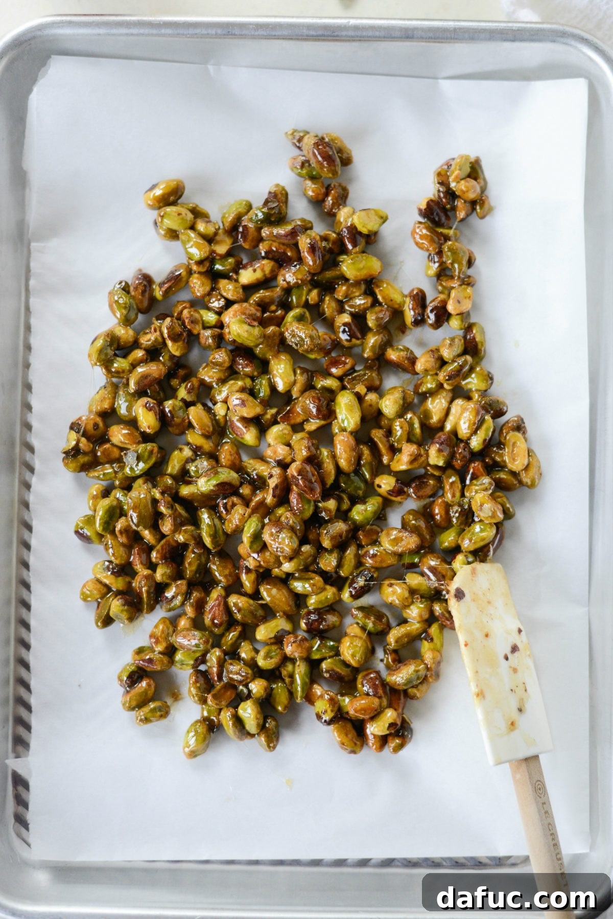 Close-up shot of perfectly candied pistachios, glistening and ready for the salad.