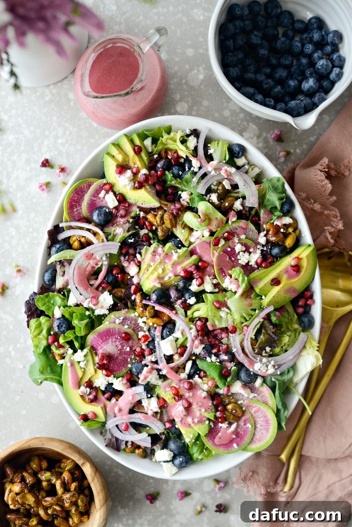 A close-up of the dressed Blueberry Pistachio Spring Salad, showcasing textures and colors.