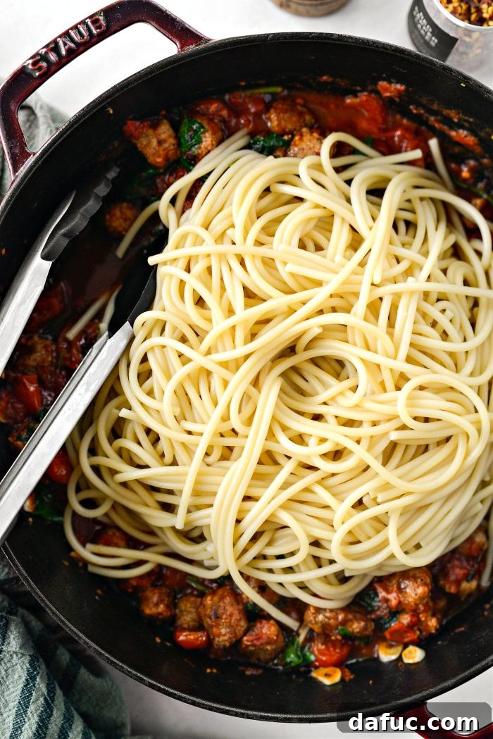 Hearty Sausage and Kale Pasta with Burst Tomatoes 12 Add cooked fettuccine pasta directly into the rich Italian sausage and tomato sauce in the skillet.
