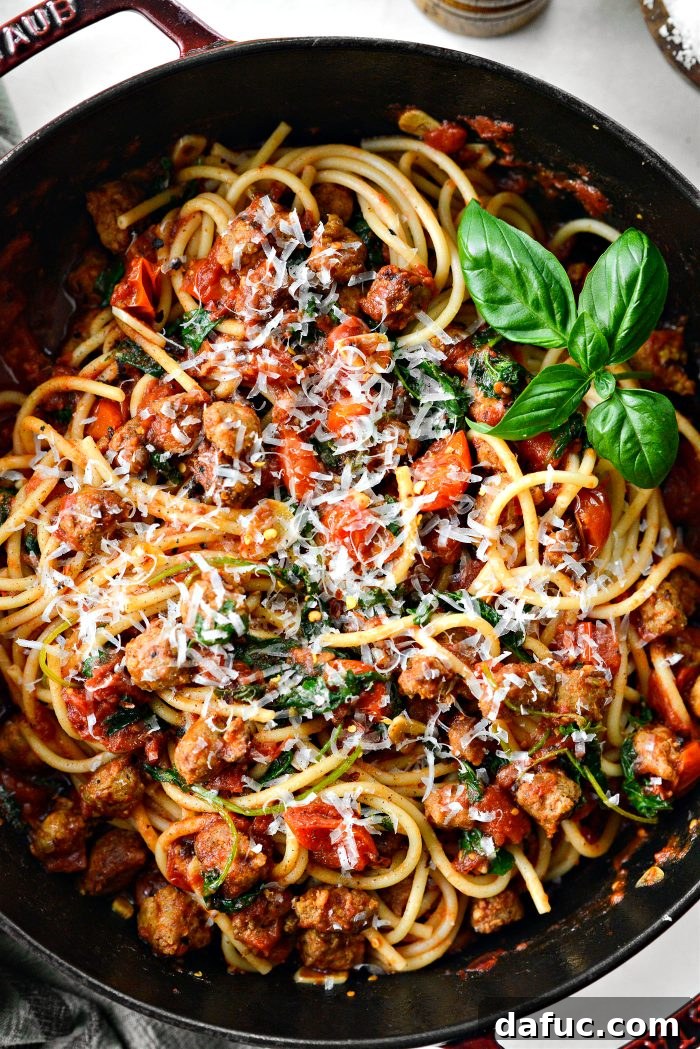 Hearty Sausage and Kale Pasta with Burst Tomatoes 15 A generous serving of Italian Sausage Tomato Kale Pasta in a bowl, garnished with cheese.