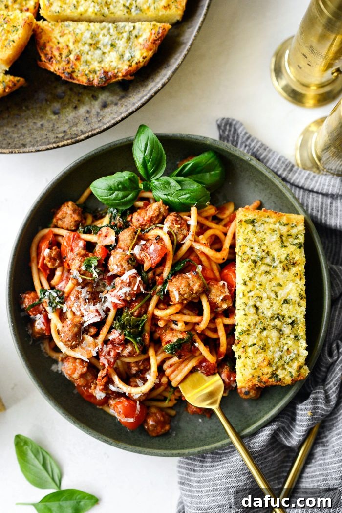 Hearty Sausage and Kale Pasta with Burst Tomatoes 16 A close-up of the Italian Sausage Tomato Kale Pasta, highlighting the textures of pasta, sausage, kale, and tomatoes.