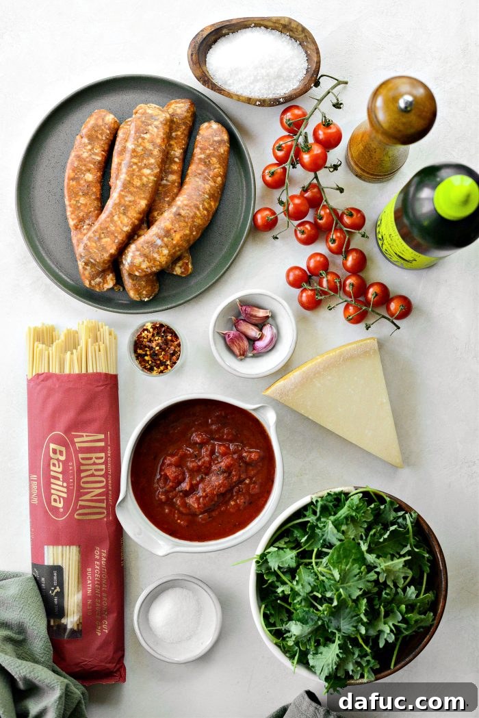 Hearty Sausage and Kale Pasta with Burst Tomatoes 4 Fresh ingredients for Italian Sausage Tomato Kale Pasta, including sausage links, cherry tomatoes, kale, garlic, and fire-roasted tomatoes.