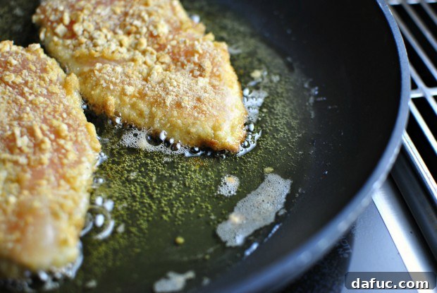 Chicken breasts browning in hot olive oil