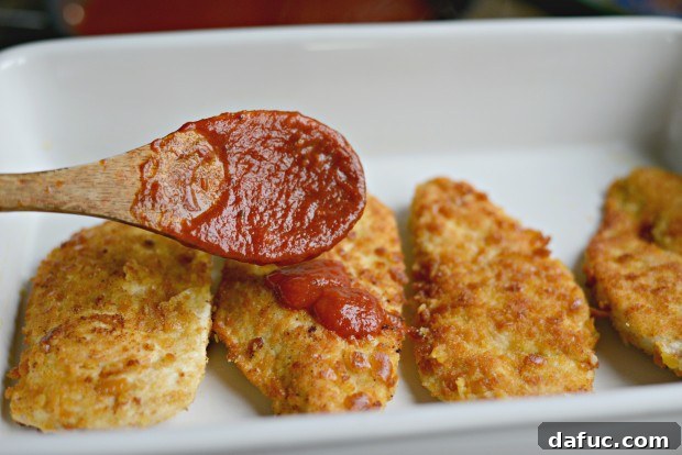 Adding Parmesan cheese to marinara sauce