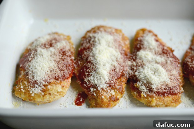 Chicken breasts generously coated with sauce