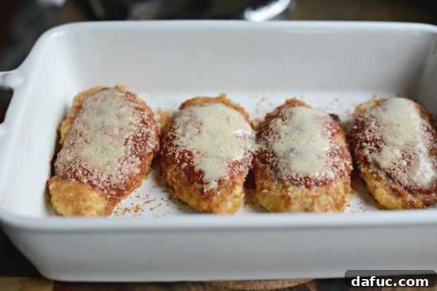 Tossing spaghetti with marinara sauce to coat