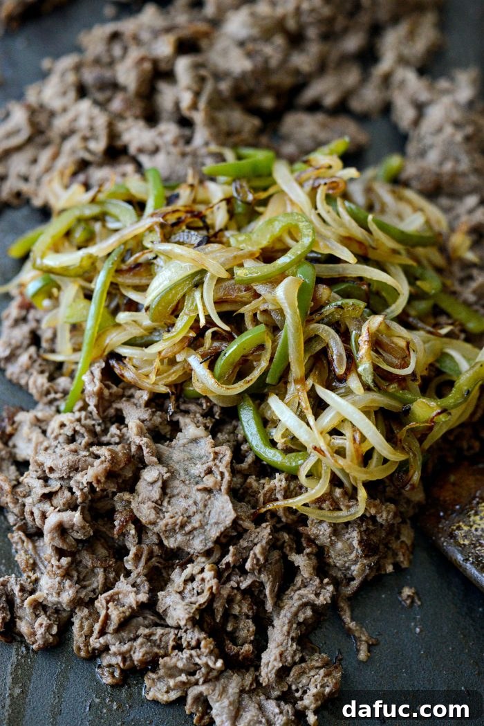 Melty, Meaty Philly Cheesesteak Magic 14 add peppers and onions to beef