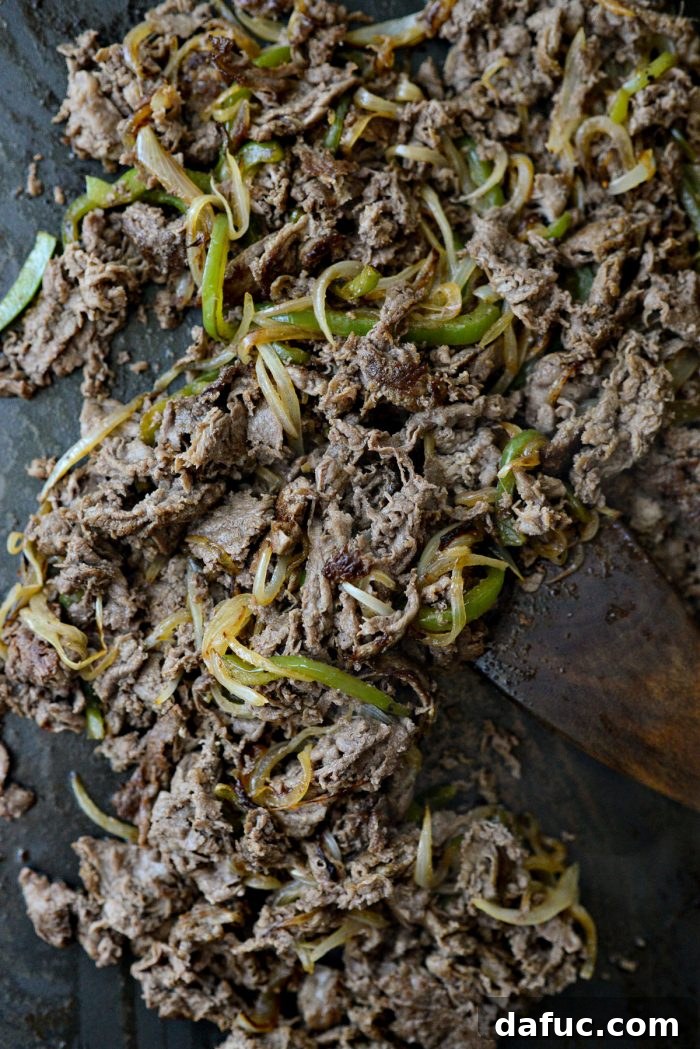 Melty, Meaty Philly Cheesesteak Magic 15 tossing peppers and onions with cooked shaved steak