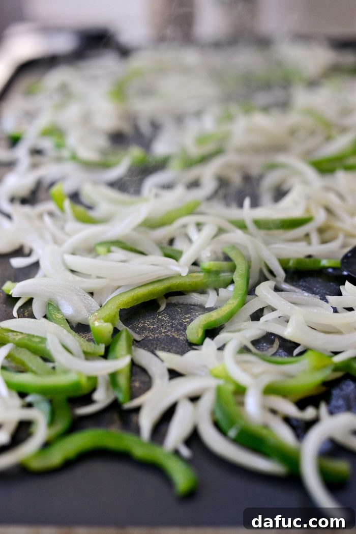 Melty, Meaty Philly Cheesesteak Magic 7 cooking onions and peppers