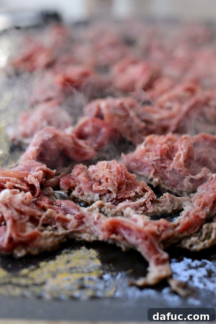 Melty, Meaty Philly Cheesesteak Magic 10 shaved steak on griddle