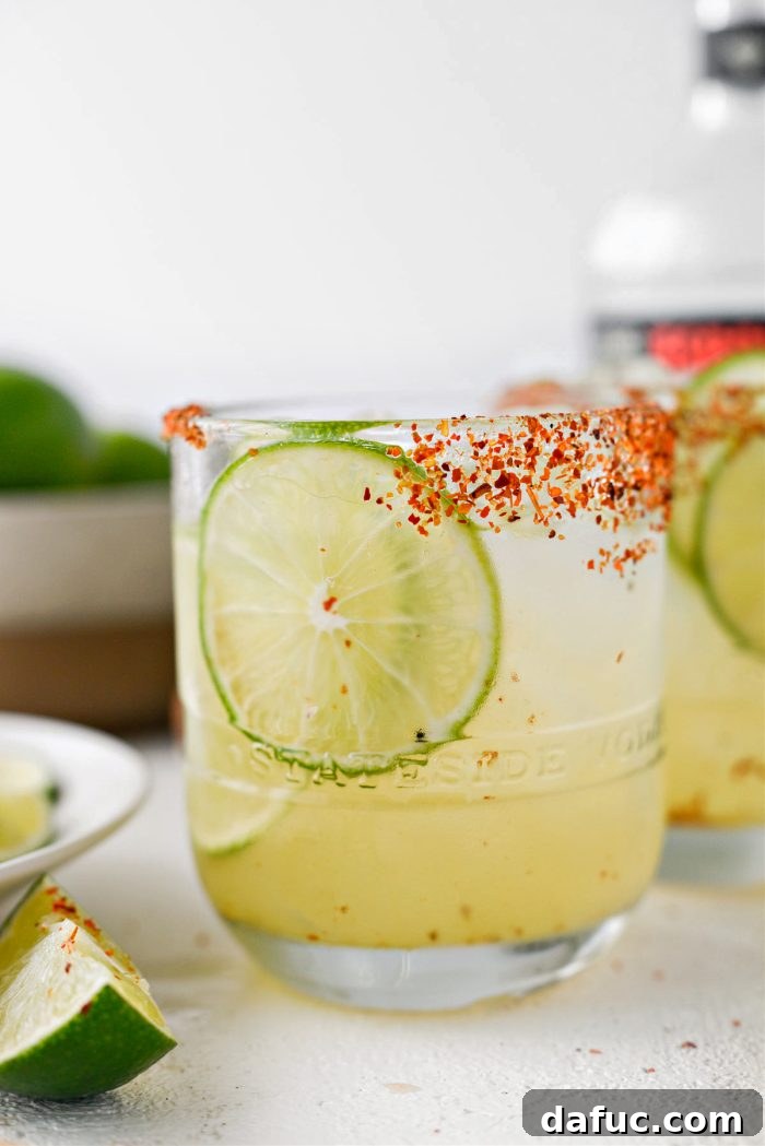A final close-up of a Honey Lime Margarita showing the icy texture and lime garnish.