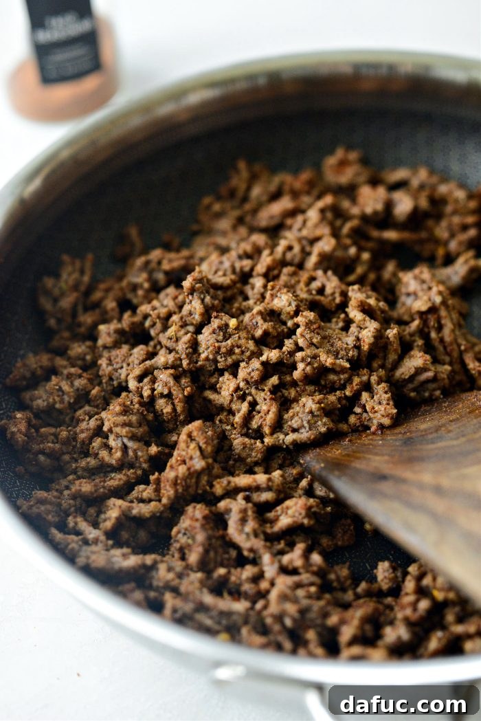 Loaded Chopped Taco Salad 7 Taco meat being stirred to combine with seasoning, then removed from heat to cool.