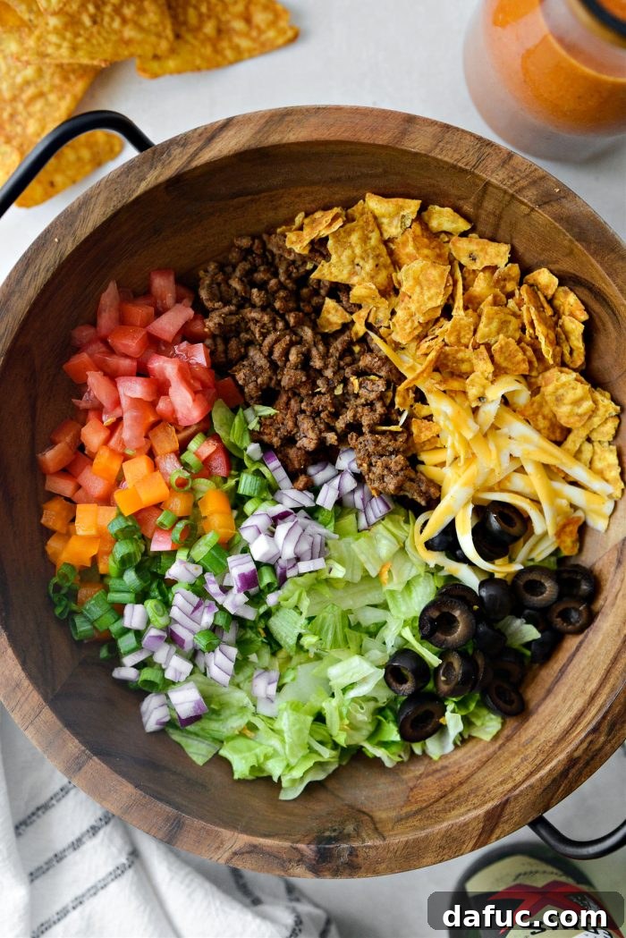 Loaded Chopped Taco Salad 8 Various chopped taco salad ingredients arranged neatly in separate bowls.