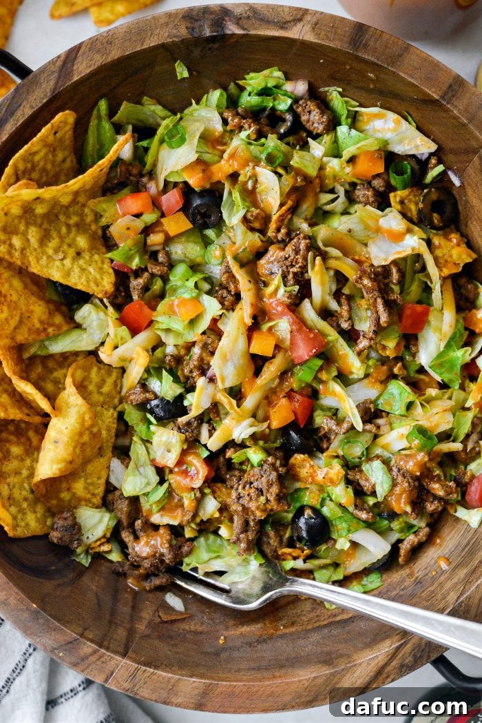 Loaded Chopped Taco Salad 10 Taco salad being tossed together in a large bowl before serving.