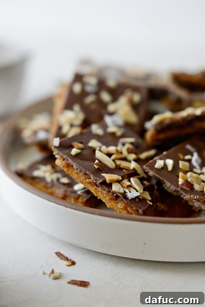 Salty Sweet Toffee Crunch 16 An enticing close-up of a broken piece of Saltine Toffee, showing the layers of cracker, toffee, and chocolate.