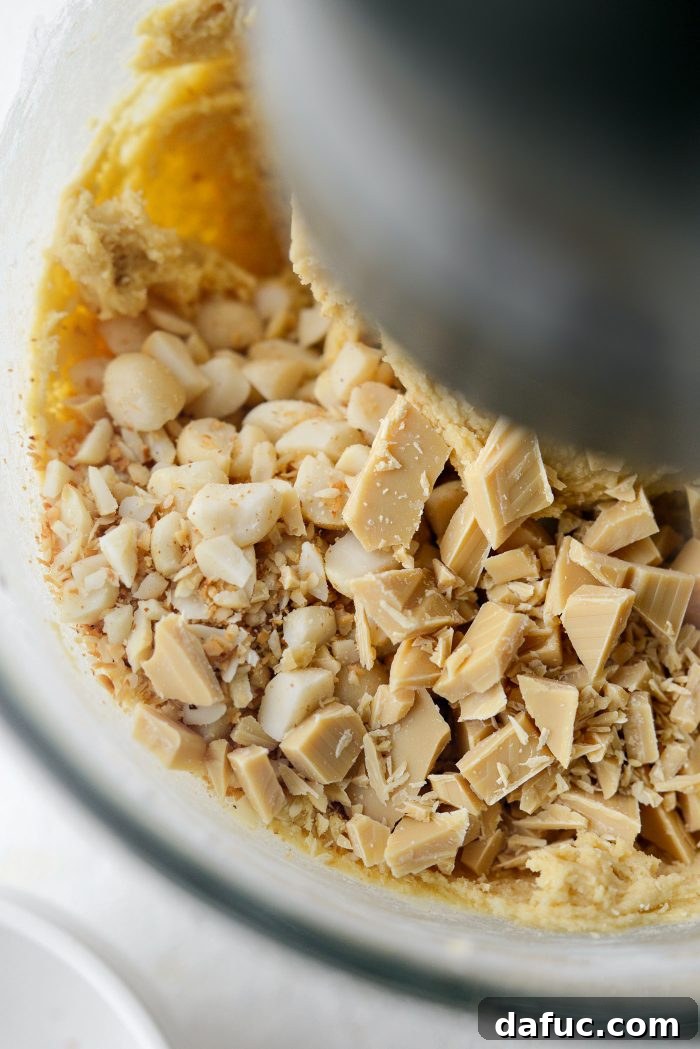 Gourmet White Chocolate Macadamia Nut Treasures 11 Adding chopped macadamia nuts and white chocolate to cookie dough