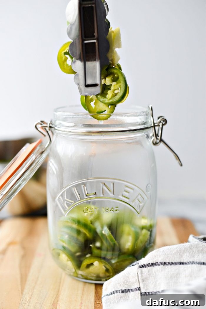 use tongs to transfer jalapenos to jar