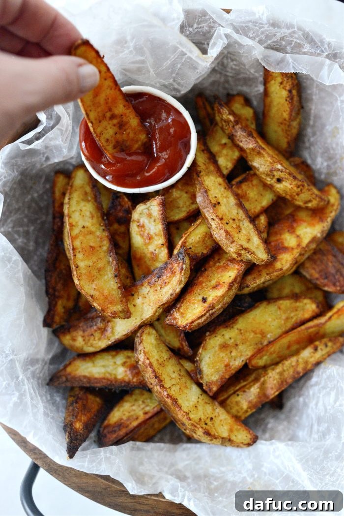 Crispy Seasoned Steak Fries 14 A large serving of crispy seasoned steak fries in a rustic bowl