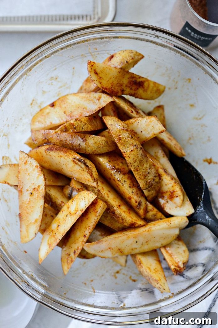 Crispy Seasoned Steak Fries 9 Final toss to combine all seasonings evenly on the potato wedges