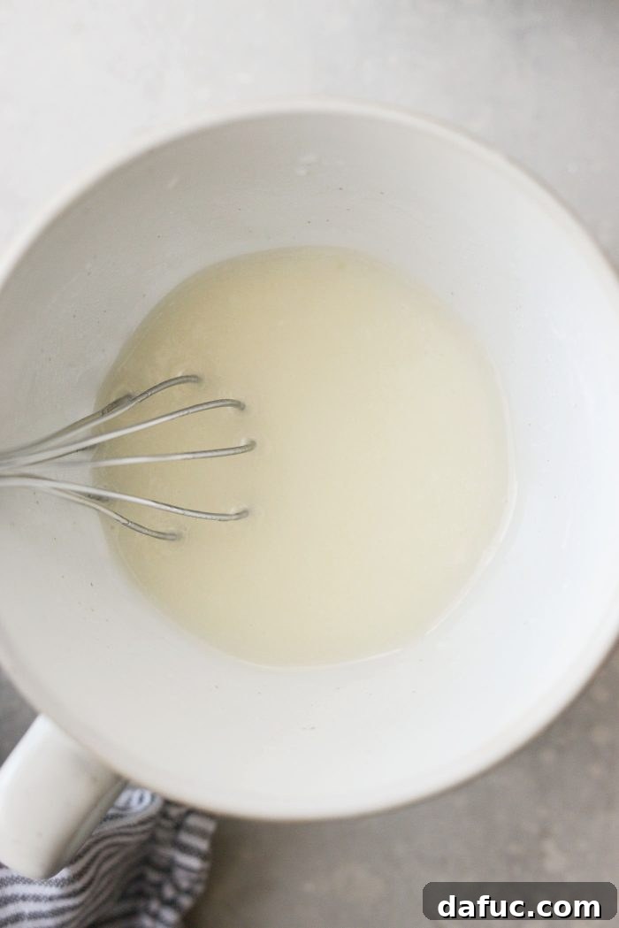 Whisking lemon glaze until smooth