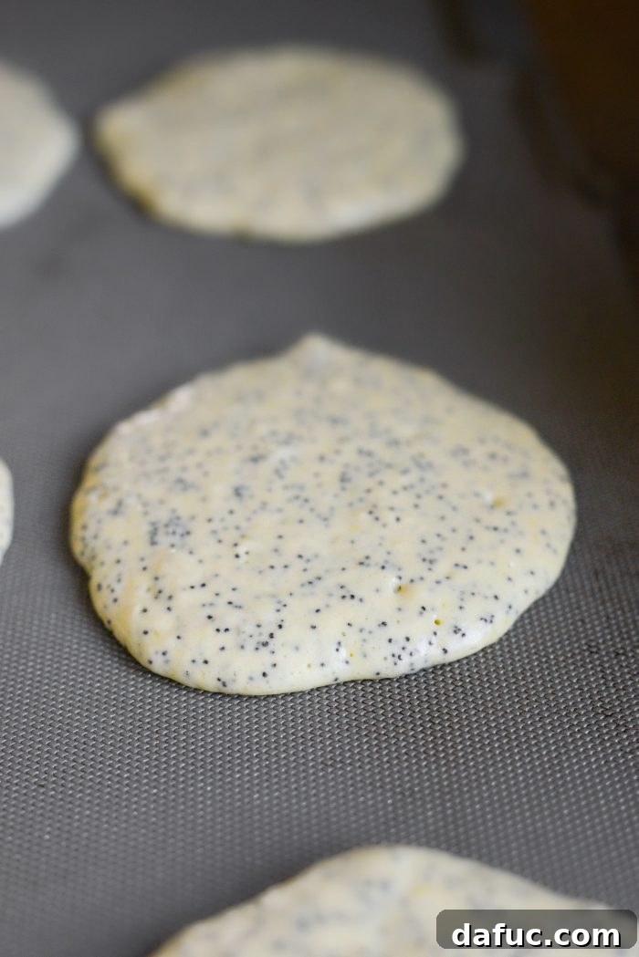 Pouring 1/4 cup batter for each lemon poppy seed pancake
