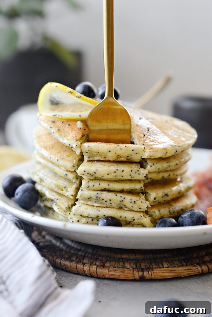 Close-up of Lemon Poppy Seed Pancakes with glaze and blueberries