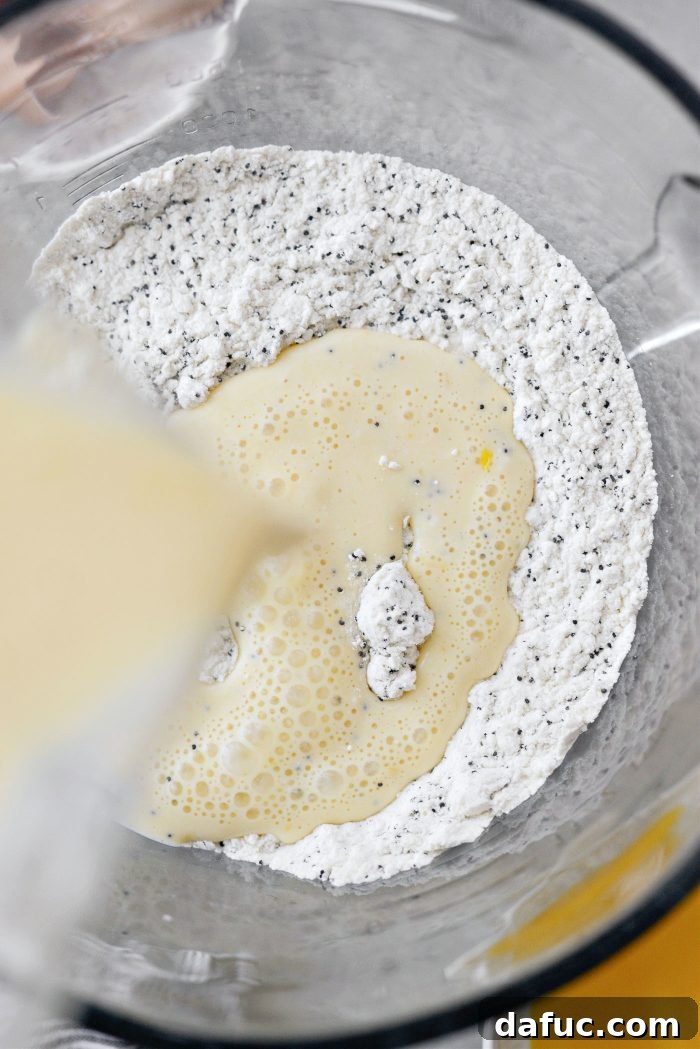 Pouring wet pancake mixture into dry ingredients