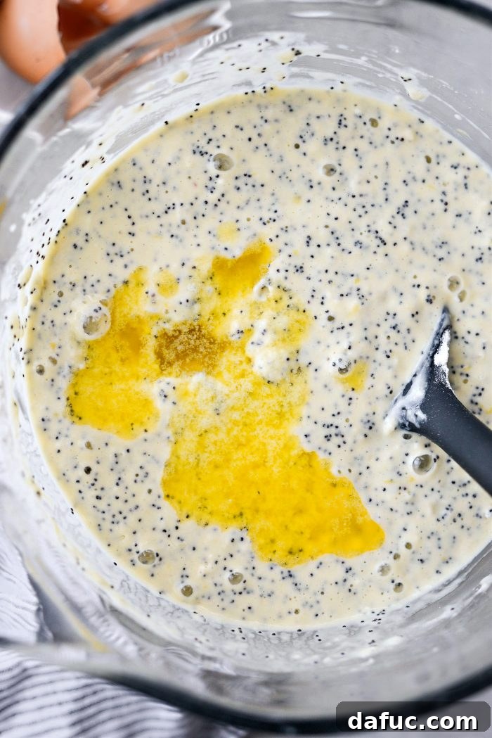 Adding melted butter to lemon poppy seed pancake batter