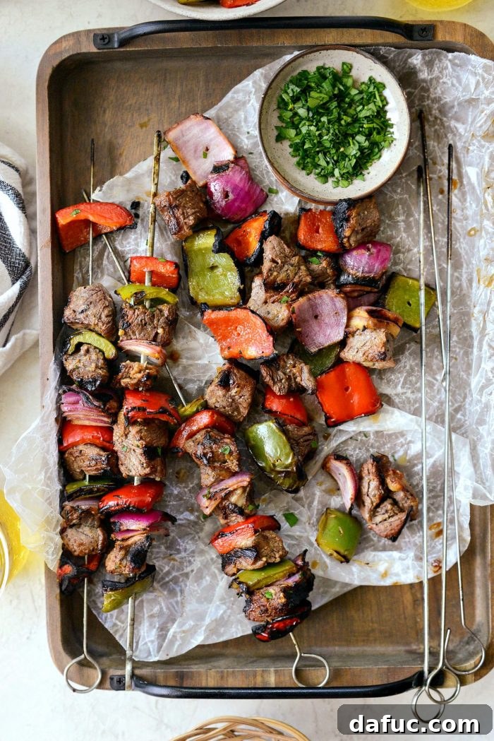 Grilled marinated steak and vegetables removed from skewers and piled on a plate