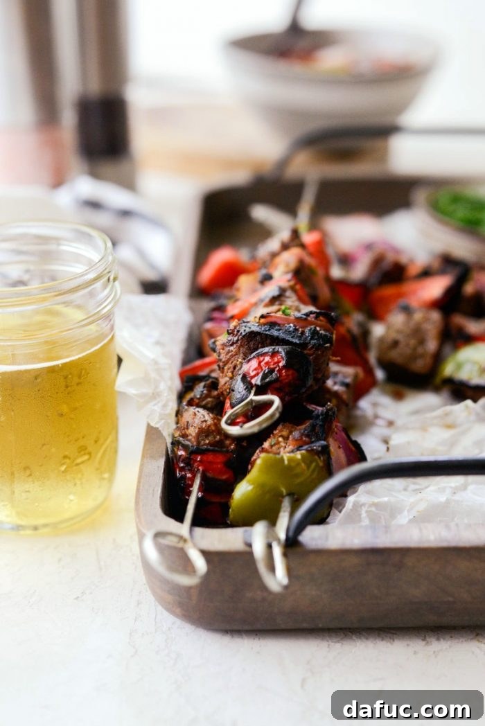 High-resolution final hero shot of grilled marinated steak kebabs on a wooden tray