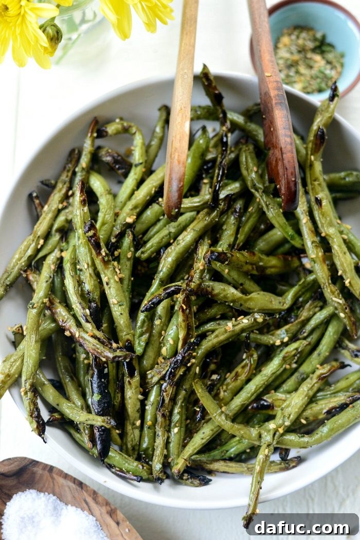 Grilled Green Beans in white bowl, perfectly charred and ready to serve.