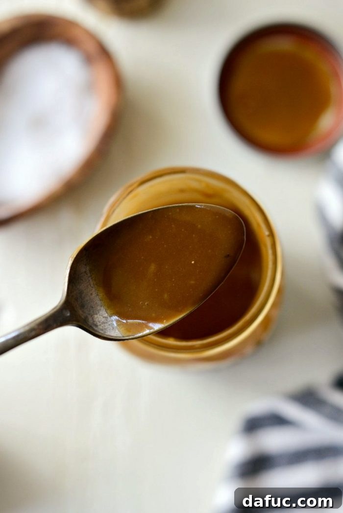 Signature Balsamic Vinaigrette 6 The perfectly emulsified house balsamic vinaigrette settled in a clear mason jar after vigorous shaking, displaying its smooth and integrated consistency.