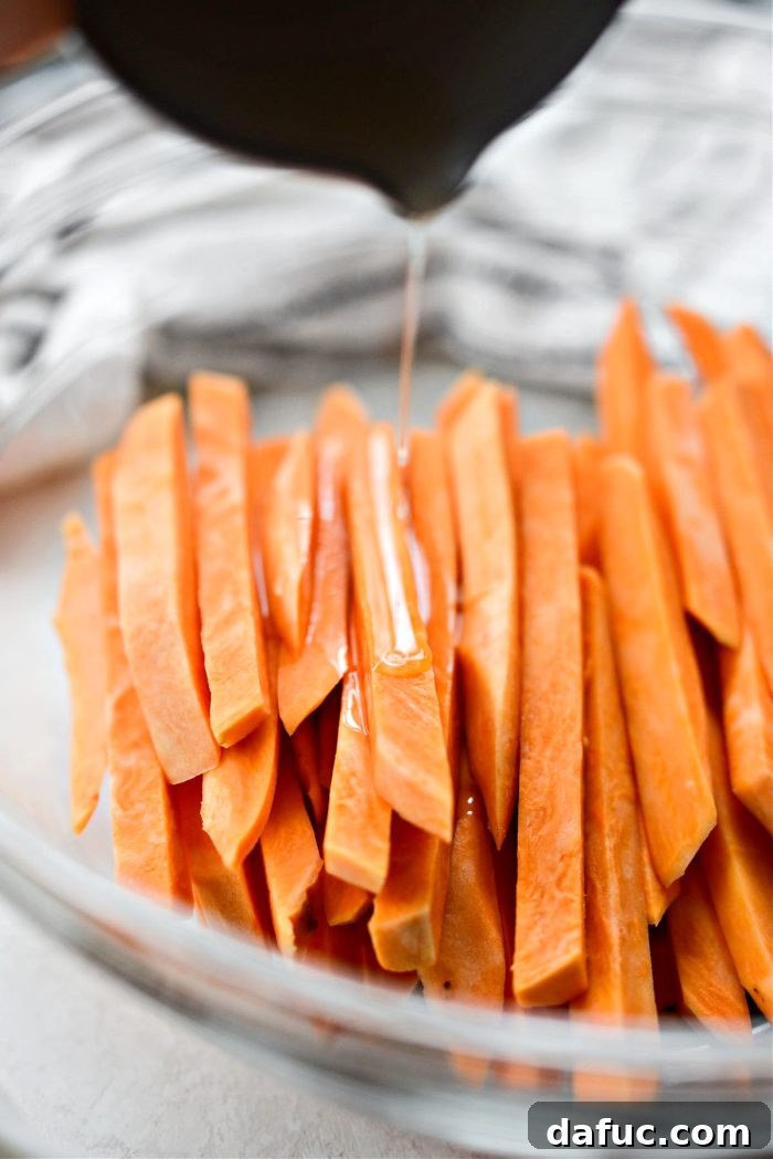 Dried sweet potato fries in a bowl, drizzled with avocado oil