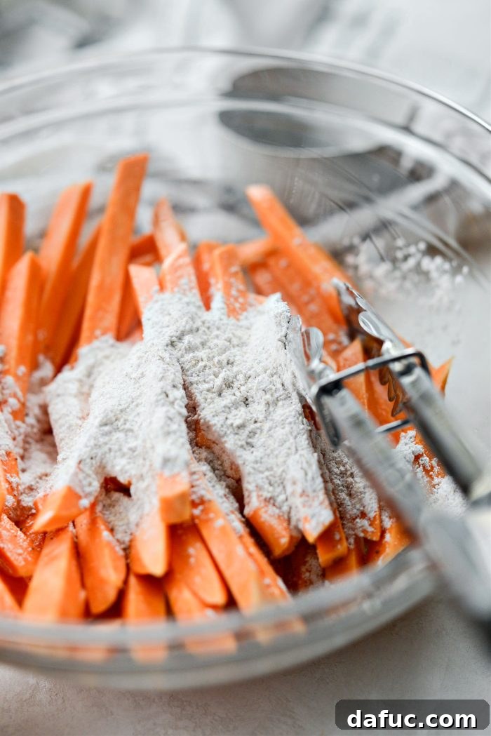 Sweet potato fries with the seasoned cornstarch added, ready for the final toss