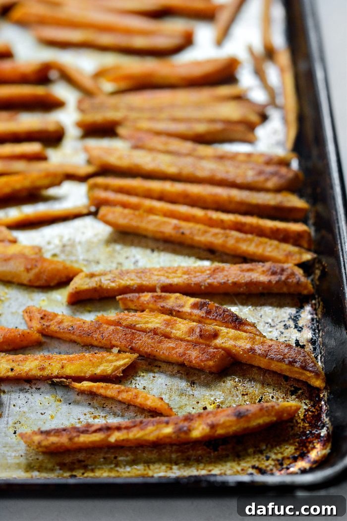 Crispy sweet potato fries in the oven, nearly golden and perfectly baked