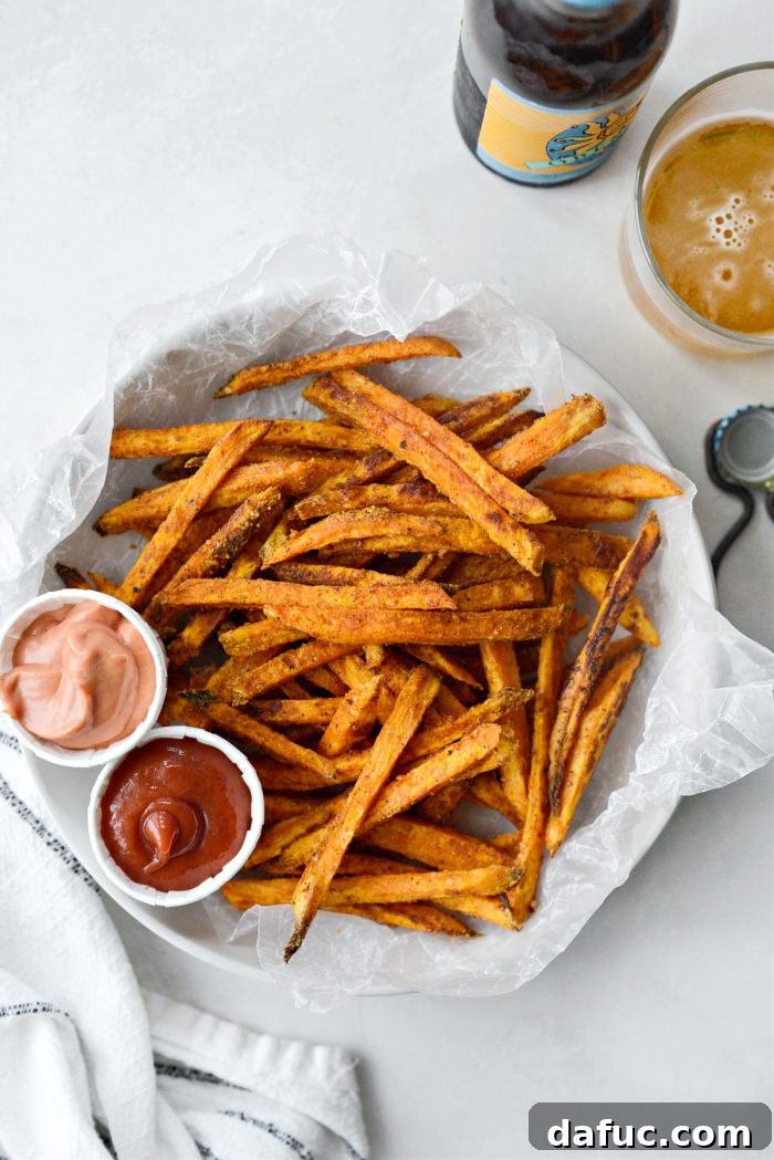 A serving of crispy baked sweet potato fries, golden and ready to eat