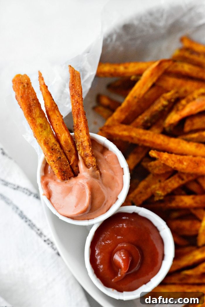 Close-up view of perfectly golden-brown and crispy baked sweet potato fries