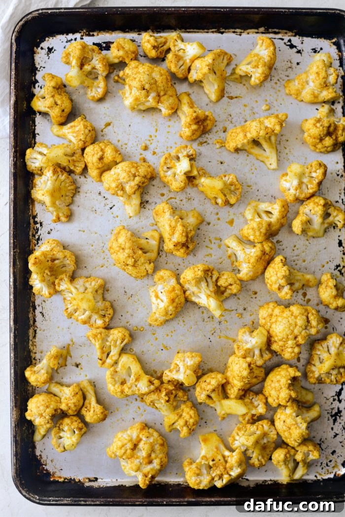 Golden Curry Roasted Cauliflower 9 Curry cauliflower spread on a roasting pan
