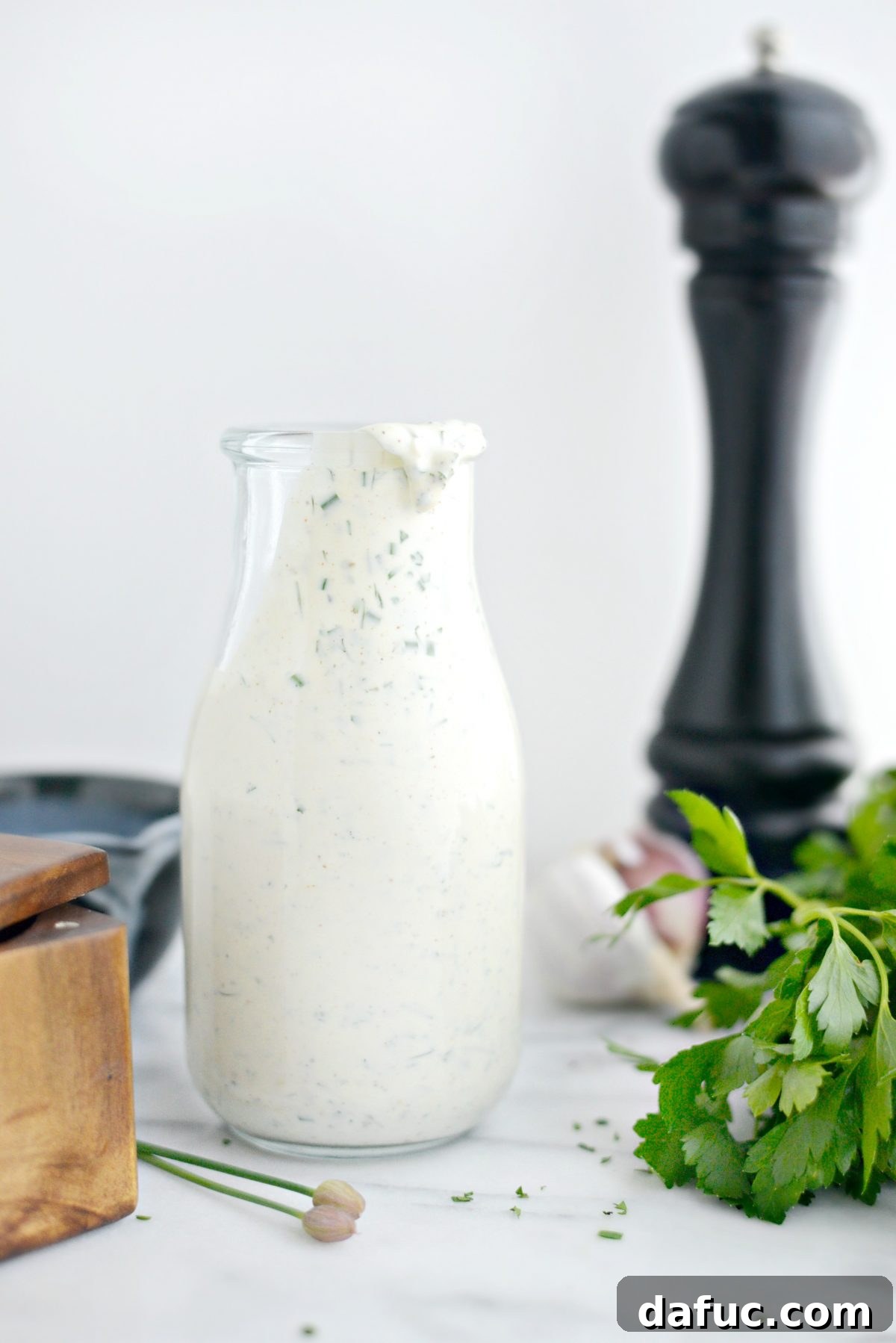 Farmhouse Ranch 2 Buttermilk Ranch Dressing in a clear glass bottle, ready to serve.